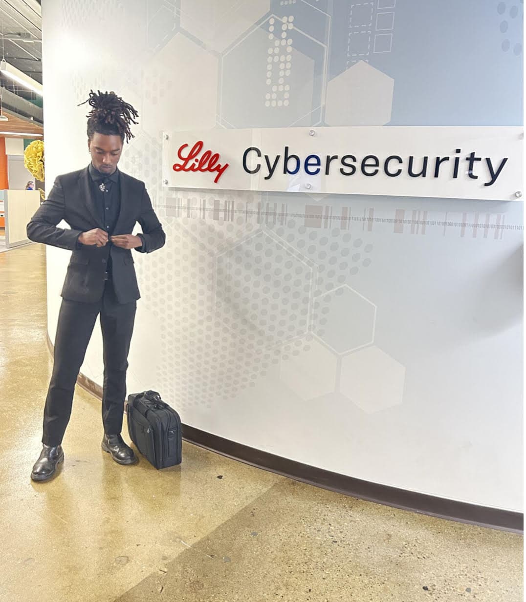 Elijah Flythe standing in front of the Lilly Cybersecurity sign
